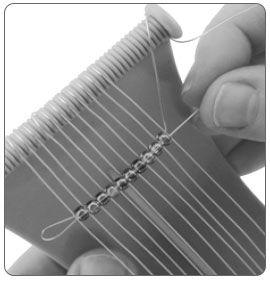 Beads threaded onto loom